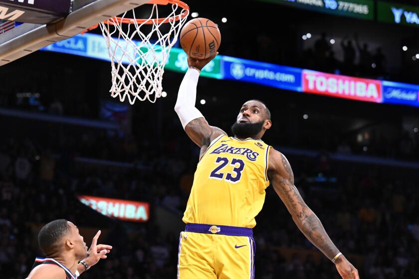 Lakers LeBron James dunks over Clippers Russell Westbrook in overtime