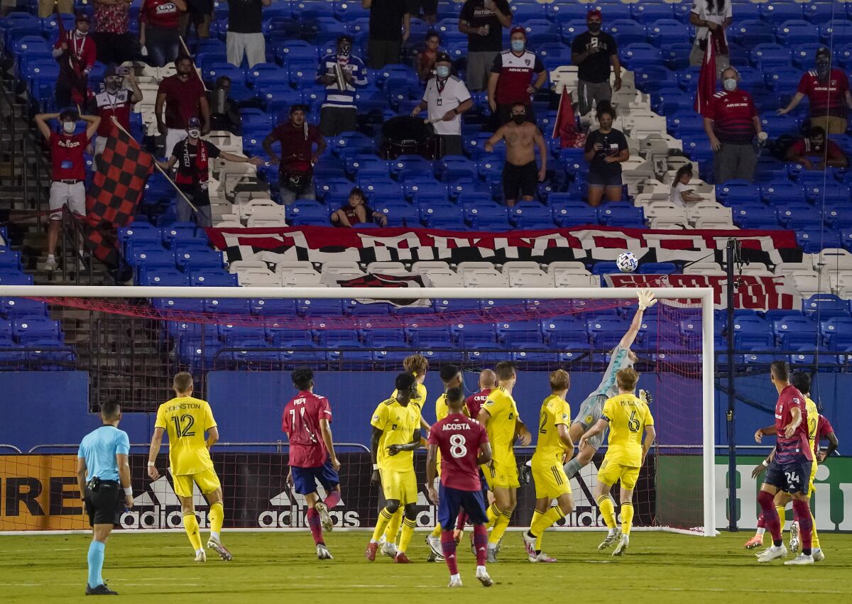 Socially distant FC Dallas supporters watch as a free kick by FC Dallas midfielder Bryan Acosta (8) sails over the bar and Nashville SC goalkeeper Joe Willis on the final play in added time of an MLS soccer game, Wednesday, Aug. 12, 2020, in Frisco, Texas. Nashville SC won the game 1-0. (Smiley N. Pool/The Dallas Morning News via AP)