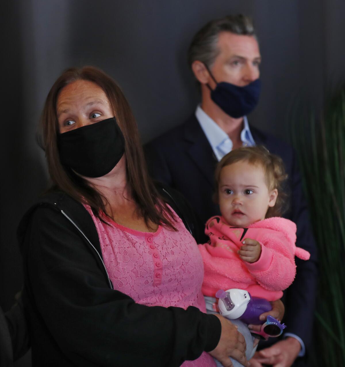 Lindsey Prescott and her daughter Mia Grace are seen with Gov. Gavin Newsom.
