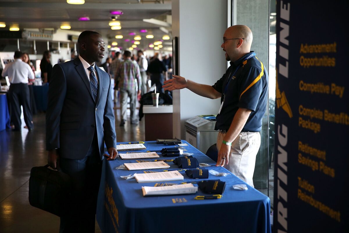 A job seeker meets with a Goodyear recruiter during the Hiring Our Heroes Job Fair at AT&T Park on Aug. 25 in San Francisco.