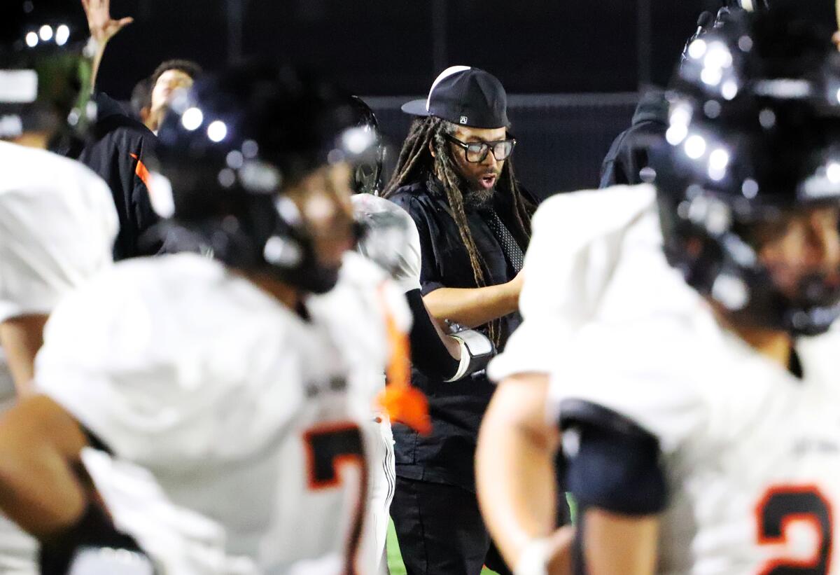 Los Amigos head coach Romel Guess calls out a play during a timeout against Artesia in a nonleague game on Friday.