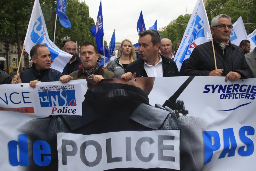 French police demonstrate June 12 with a banner reading "No police, no peace" on the Champs-Elysees avenue in Paris.
