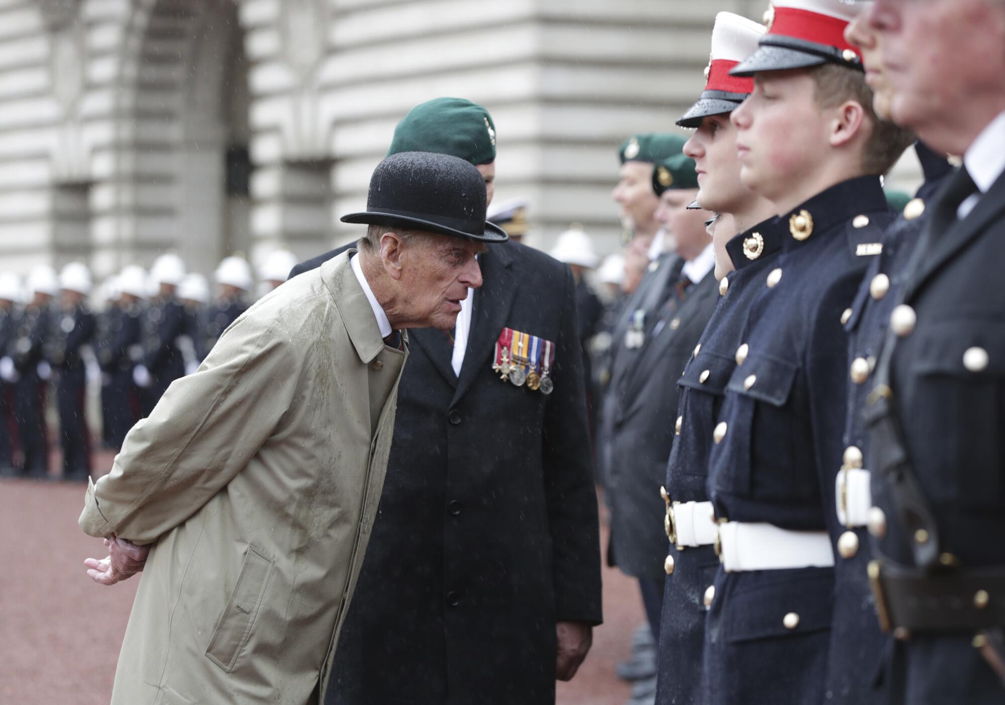 Prince Philip, in his role as Captain-General of the Royal Marines, talks to uniformed troops.