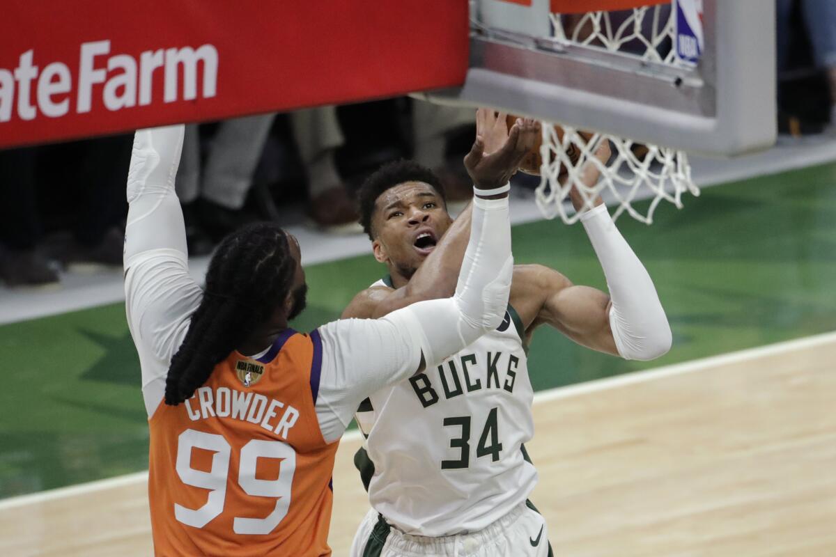 Milwaukee Bucks forward Giannis Antetokounmpo shoots over Phoenix Suns forward Jae Crowder.