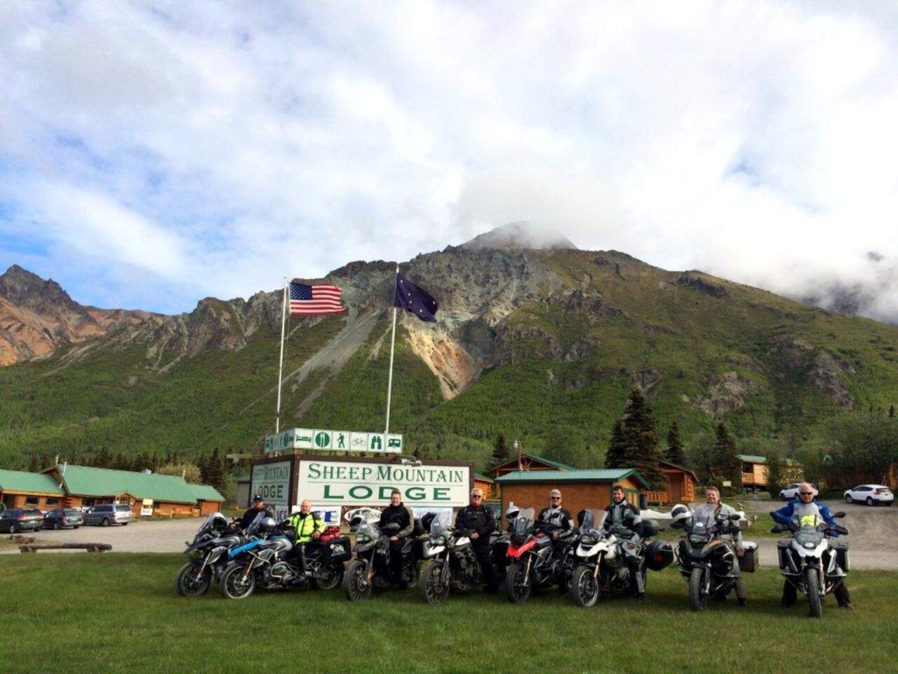 The riders astride their mounts in front of Sheep Mountain Lodge, on Alaska's Glenn Highway.