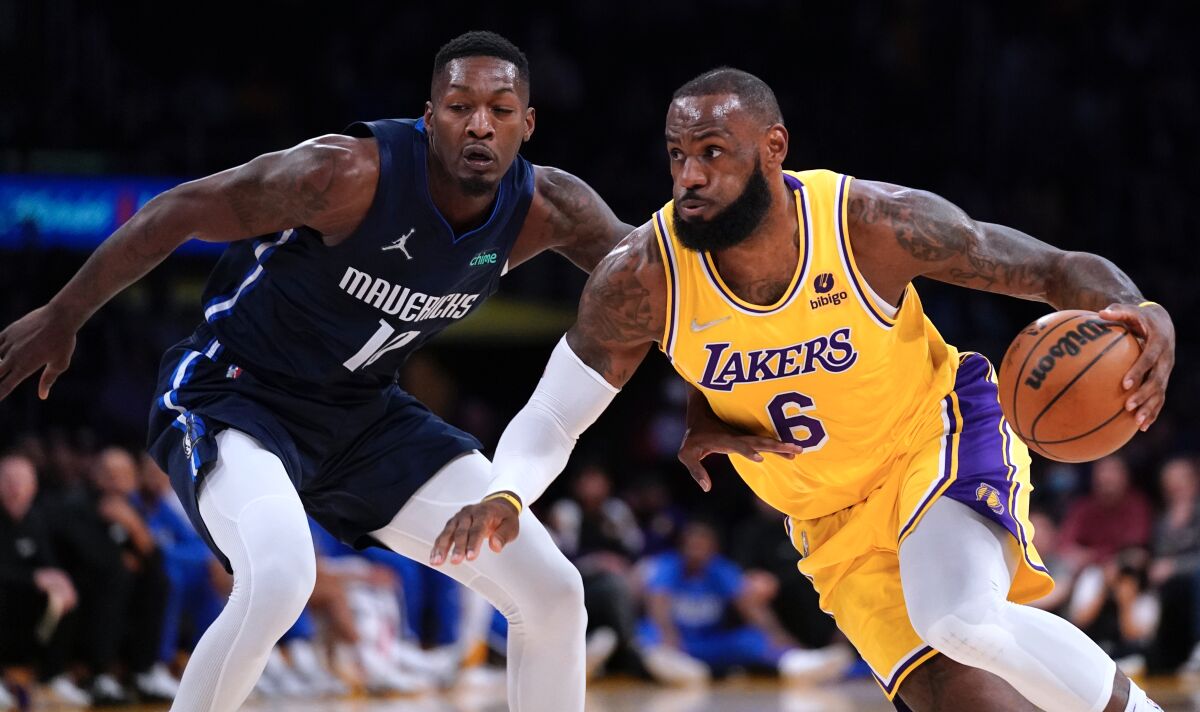 Lebron James drives past Dallas Mavericks' Dorian Finney-Smith on March 1 at Crypto.com Arena.