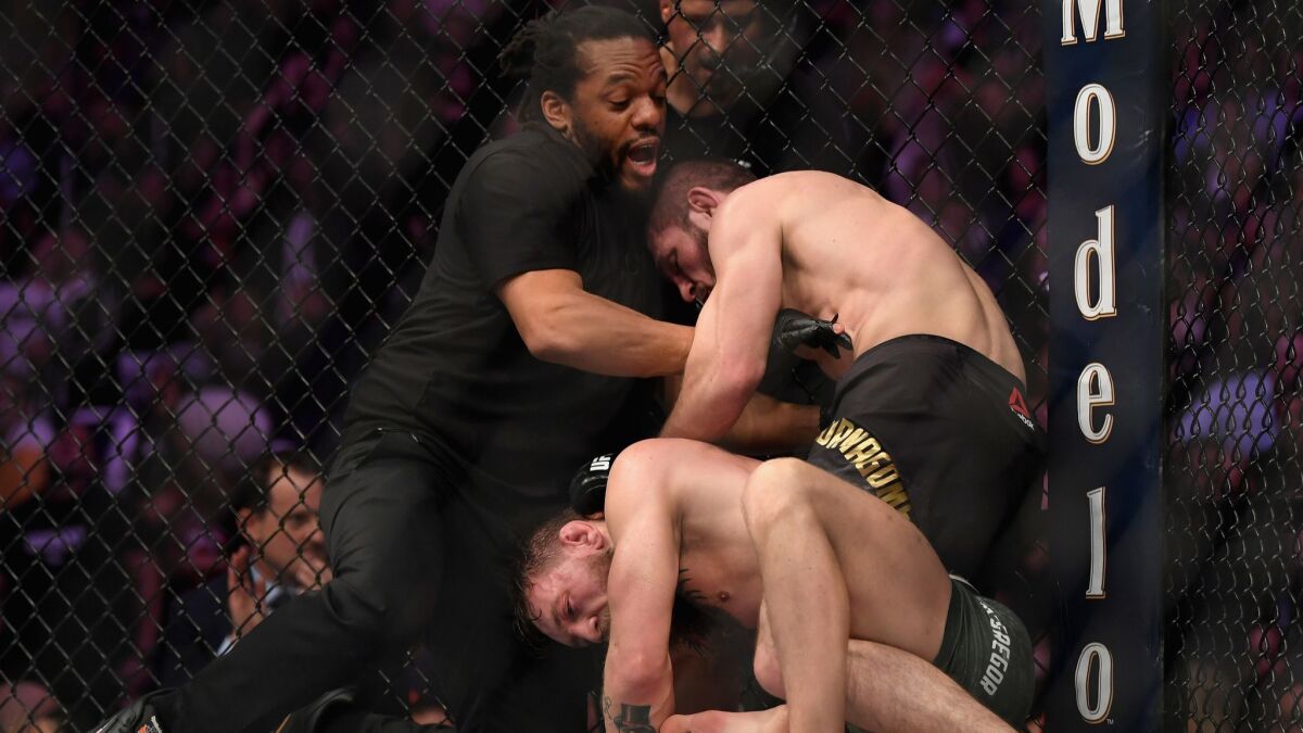 Referee Herb Dean separates Khabib Nurmagomedov of Russia from Conor McGregor of Ireland after McGregor tapped out in their UFC lightweight championship bout during UFC 229.