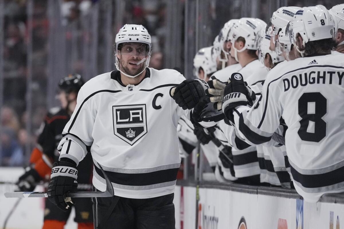 Anze Kopitar bumps fists with Kings teammates.