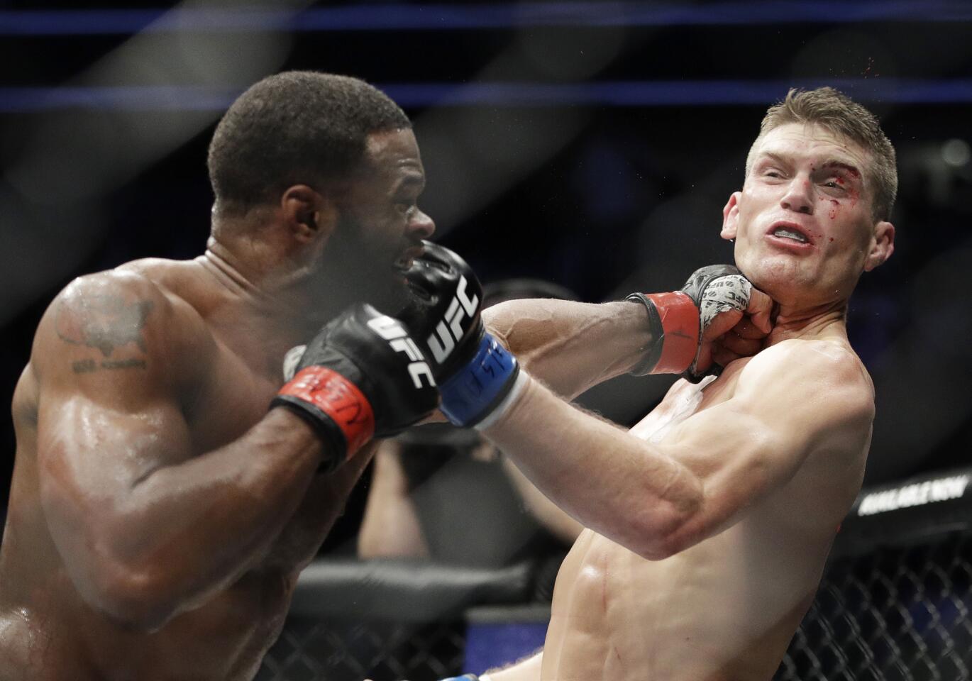 Tyron Woodley, left, hits Stephen Thompson in a welterweight championship mixed martial arts bout at UFC 209, Saturday, March 4, 2017, in Las Vegas. (AP Photo/John Locher)