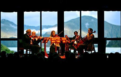 Mountains provide a dramatic backdrop to a Sitka Summer Music Festival evening concert at Harrigan Centennial Hall.