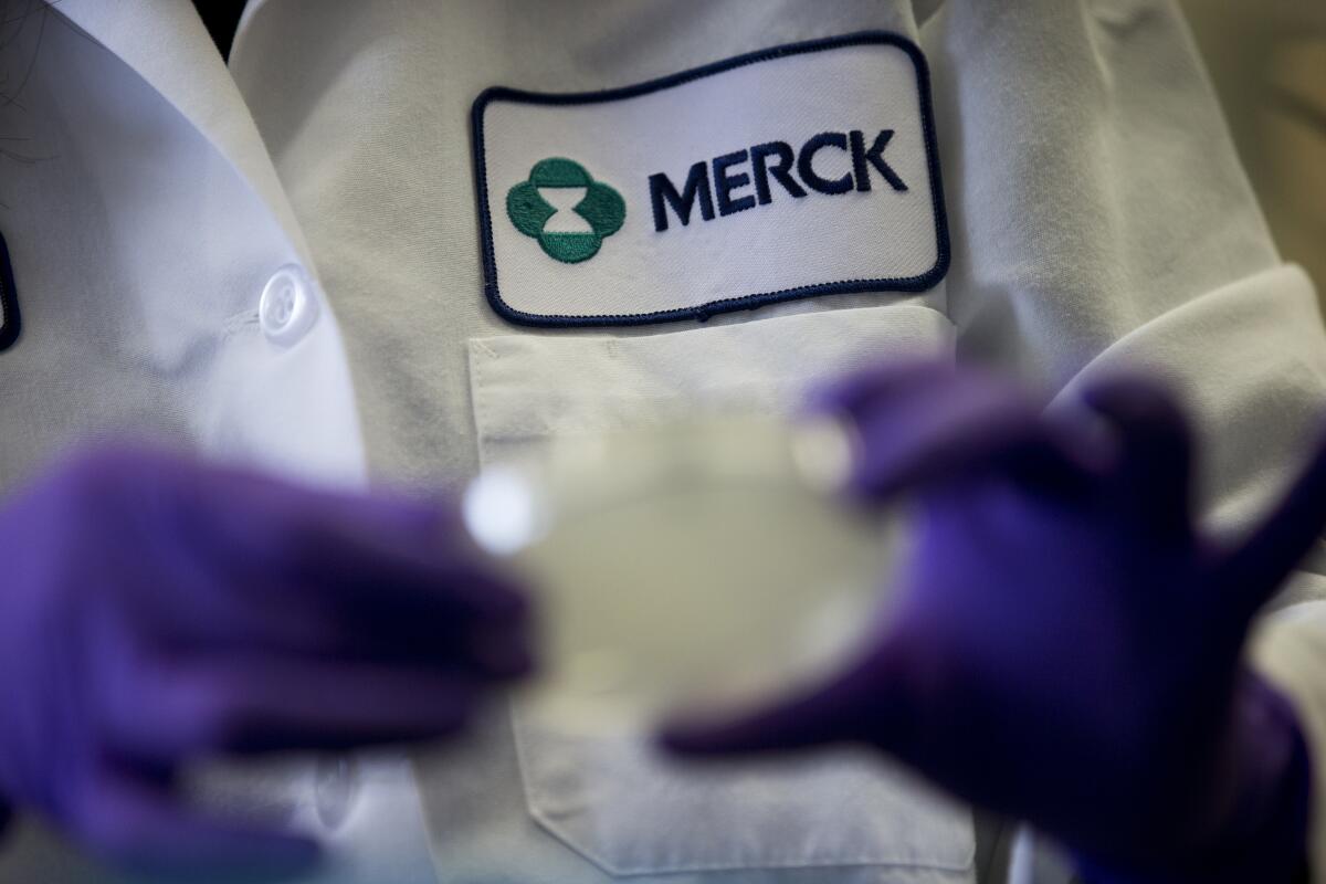 A scientist works in a Merck lab. 