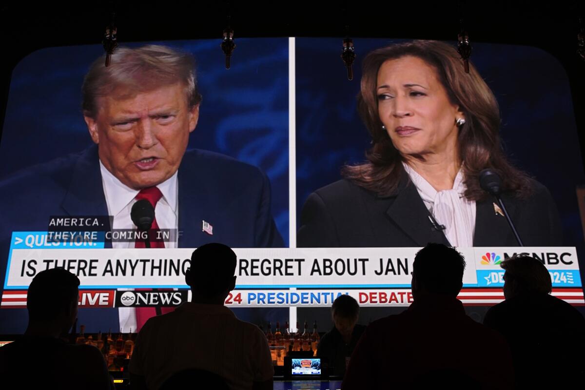 People watch the presidential debate between Donald Trump and Kamala Harris