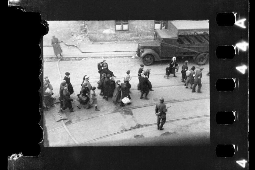 This handout negative dated on April 20, 1943, and taken by Polish firefighter Zbigniew Leszek Grzywaczewski negative shows jewish people being evacuated from the Ghetto to Umschlagplatz during the uprising of the Warsaw ghetto in 1943, Poland. On Wednesday, Jan. 18, 2023, Warsaw’s Jewish history museum presented a group of photographs taken in secret during the Warsaw Ghetto Uprising of 1943, some of which have never been seen before, that were recently discovered in a family collection. (Z. L. Grzywaczewski/courtesy of Maciej Grzywaczewski/POLIN Museum via AP)