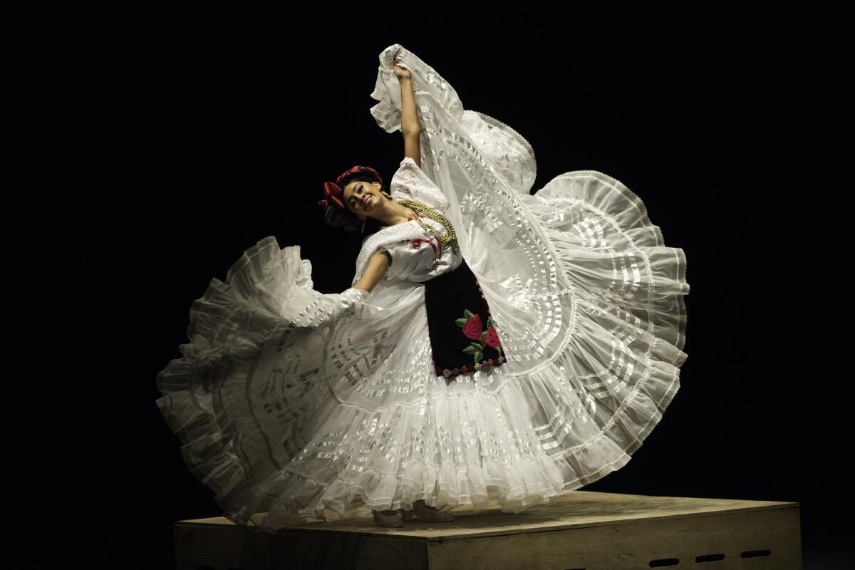 A dancer's skirt swirls up during a step.