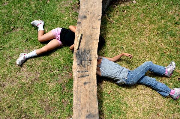 Two young campers play tic-tac-toe with charcoal at El Capitan Canyon.