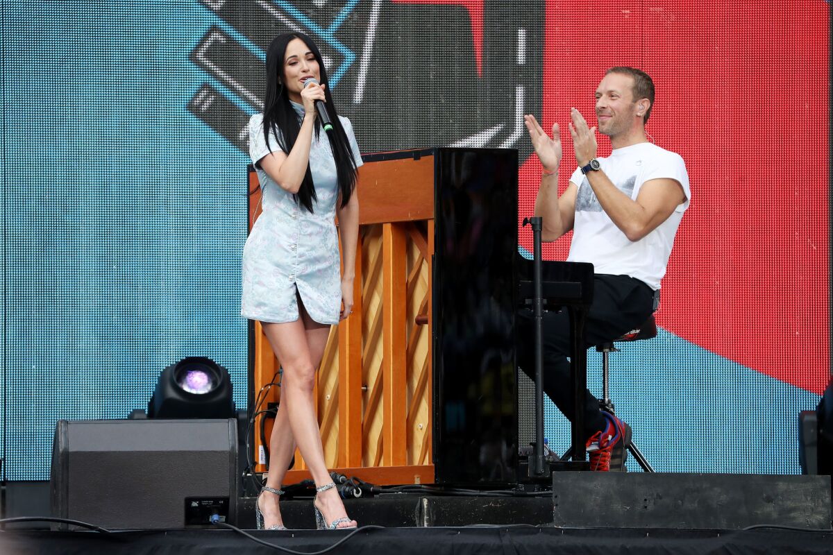 Kacey Musgraves and Coldplay's Chris Martin perform during this month's Global Citizen Festival at FNB Stadium in Johannesburg, South Africa.