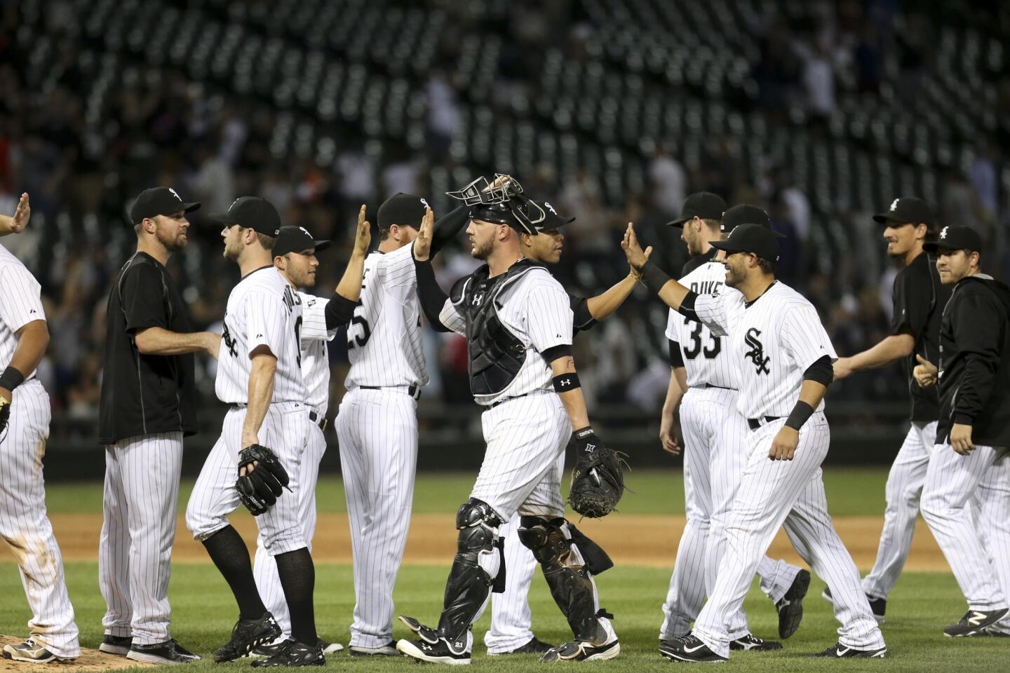 White Sox players celebrate after defeating the Houston Astros.