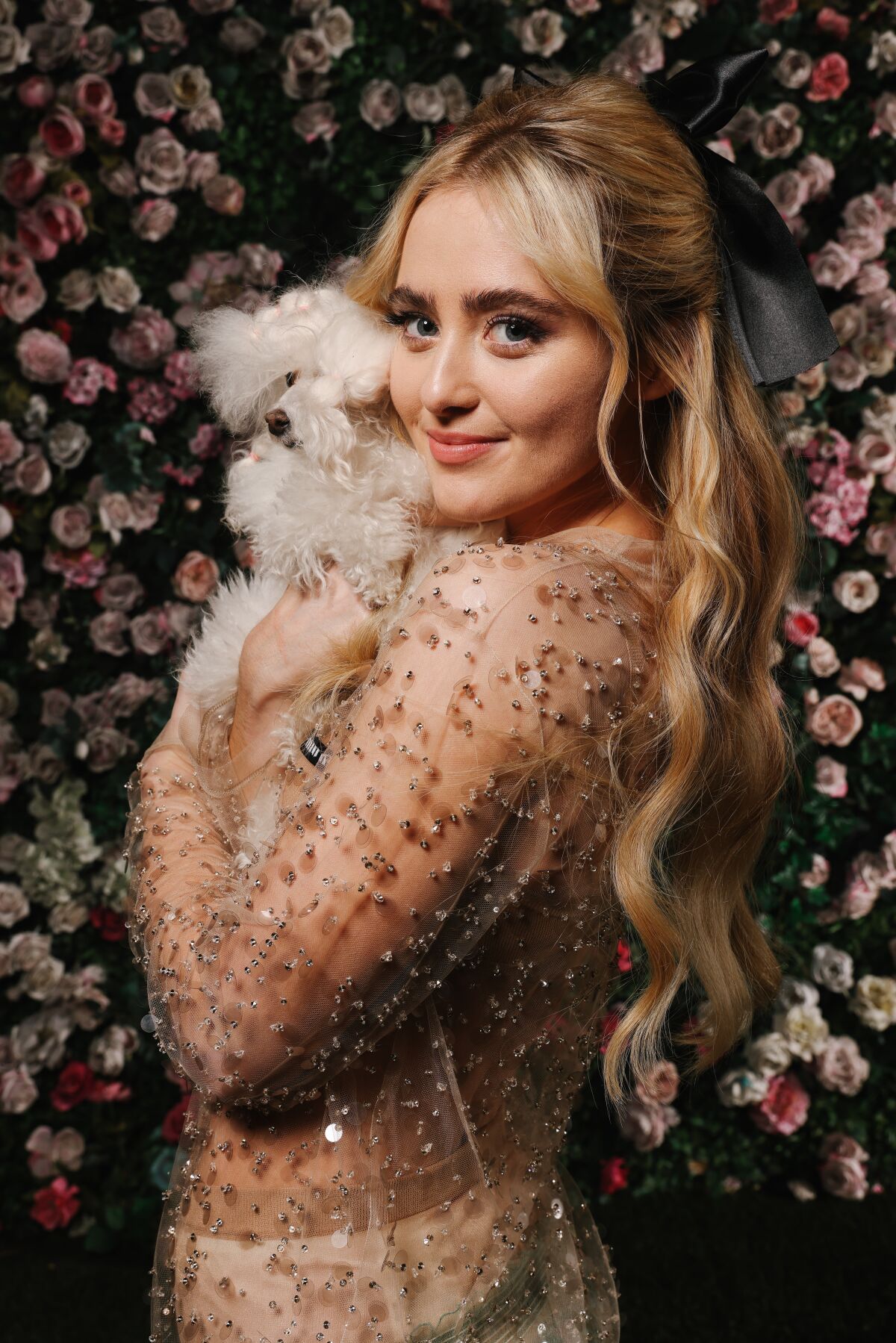 actor Kathryn Newton holds a dog