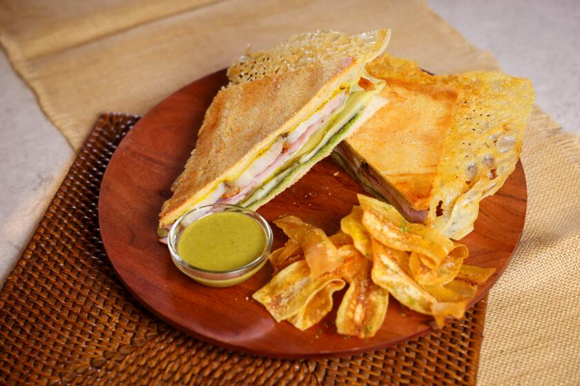 EL SEGUNDO-CA-MAY 30, 2024: Plated Cubanos with dipping sauce and fried burro bananas by Chef Jordan Kahn at the Los Angeles Times on May 30, 2024. (Christina House / Los Angeles Times)