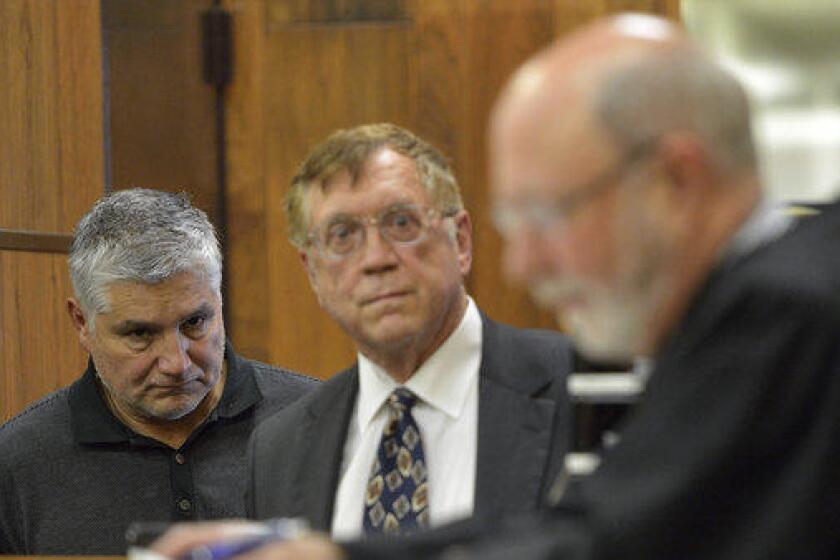 Former teacher Robert Pimentel, left, with attorney Richard Knickerbocker, center, appears in court in 2013.