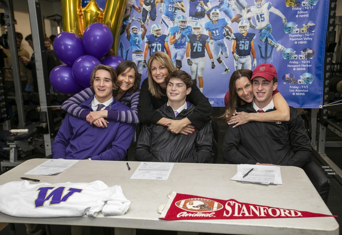 Corona del Mar's Mark Redman, left, with his mother, Maria, Ethan Garbers, center, with his mom, Angelique, and John Humphreys with his mom, Wendy, pose for a photo with the seniors on Wednesday.