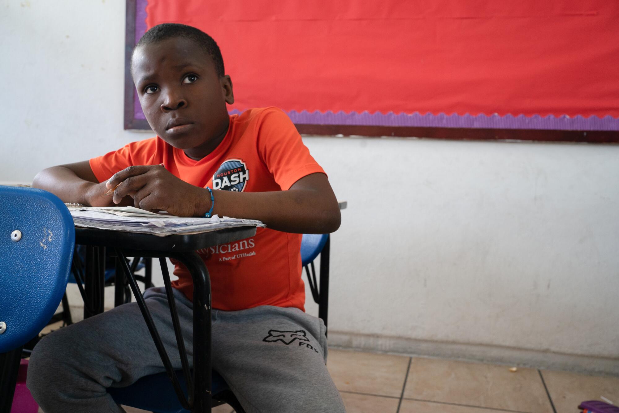 Fleurin Fletcher, 10, copies down a lesson written on the board