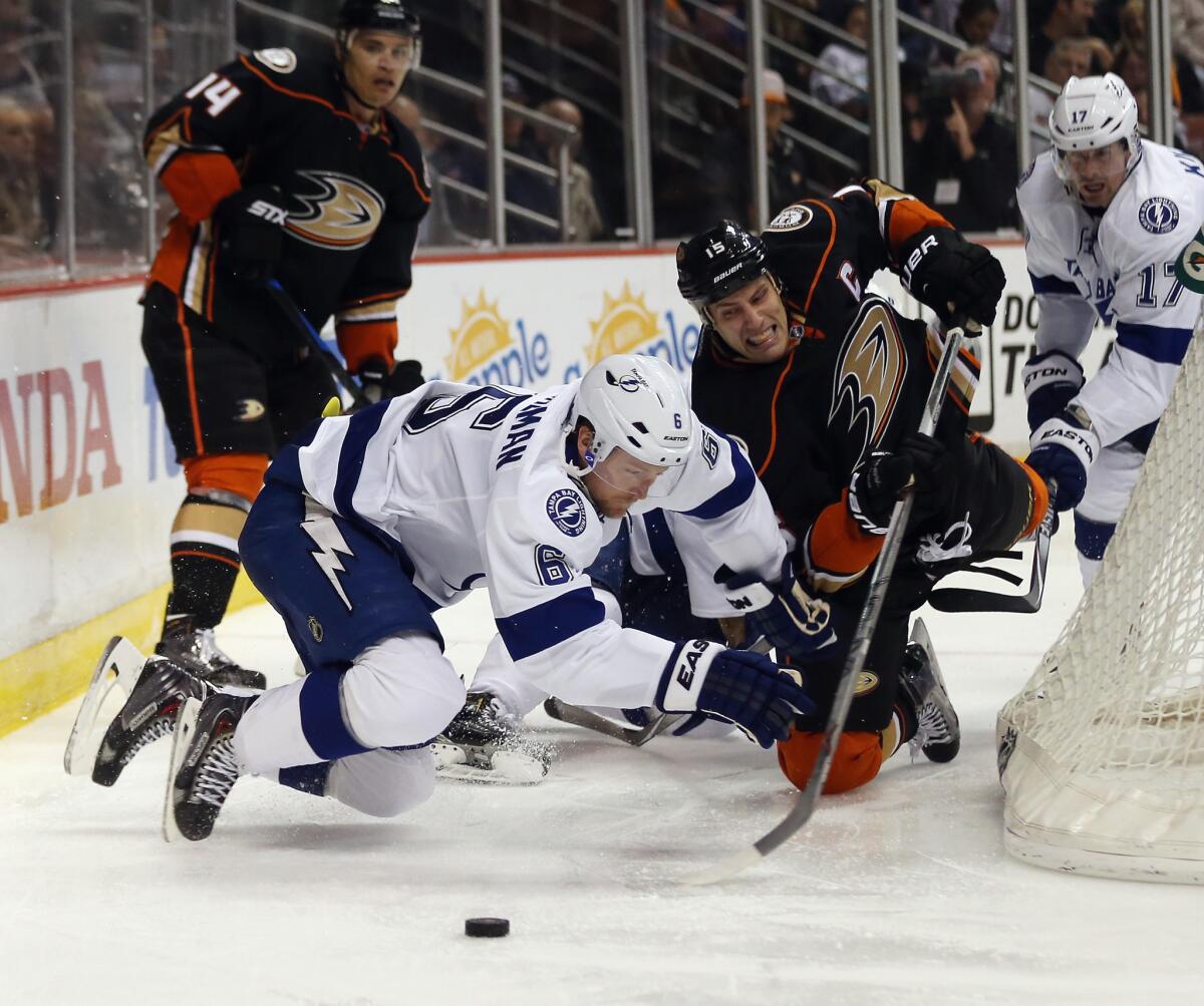 The Ducks' Ryan Getzlaf and Tampa Bay's Anton Stralman battle for the puck Wednesday at Honda Center.