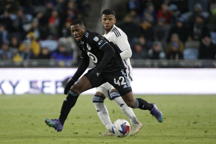 Minnesota United Emmanuel Iwe controls the ball in front of Vancouver Whitecaps midfielder Pedro Vite (45) in the second half of an MLS soccer game Saturday, March 25, 2023, in St. Paul, Minn. (AP Photo/Andy Clayton-King)