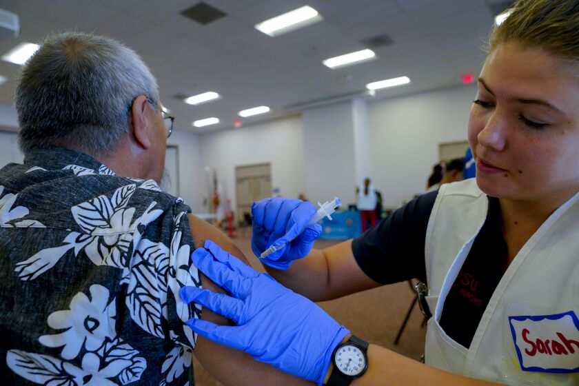 On Tuesday, October 15, 2019 Sarah Tomason was among the volunteers working with staff from The County of San Diego Health and Human Services Agency to provided free influenza and hepatitis A vaccinations to the public at the Martin Luther King Jr. Community Center in National City. Receiving his flu vaccination is George David, 63 from San Diego.