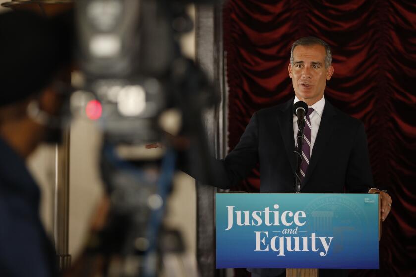 LOS ANGELES, CA - JUNE 02: Los Angeles Mayor Eric Garcetti addresses a press conference while he signs his 2021-2022 budget flanked by LA City council members in the Tom Bradley room of Los Angeles City Hall on Wednesday June 2, 2021. City Hall on Wednesday, June 2, 2021 in Los Angeles, CA. (Al Seib / Los Angeles Times).