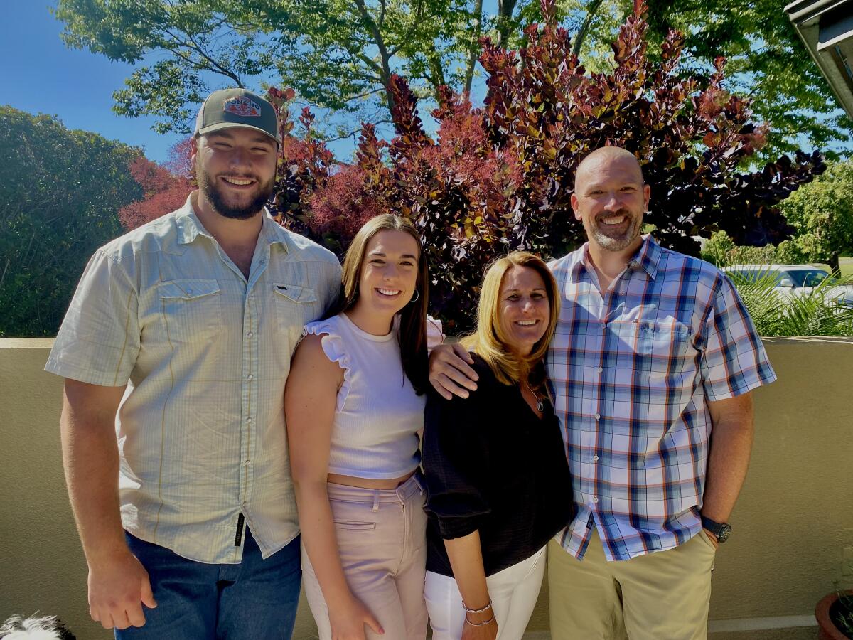 Former UCLA football player Thomas Cole, left, is joined by his sister, Katie; his mother, Kelli; and his father, David.