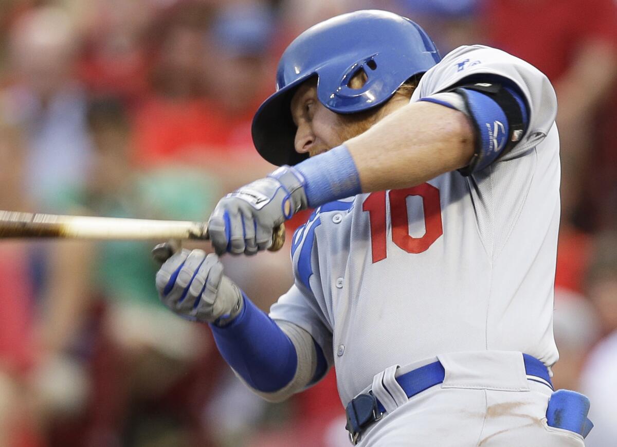Dodgers third baseman Justin Turner gets an RBI hit off Cincinnati pitcher Tony Cingrani on Monday.