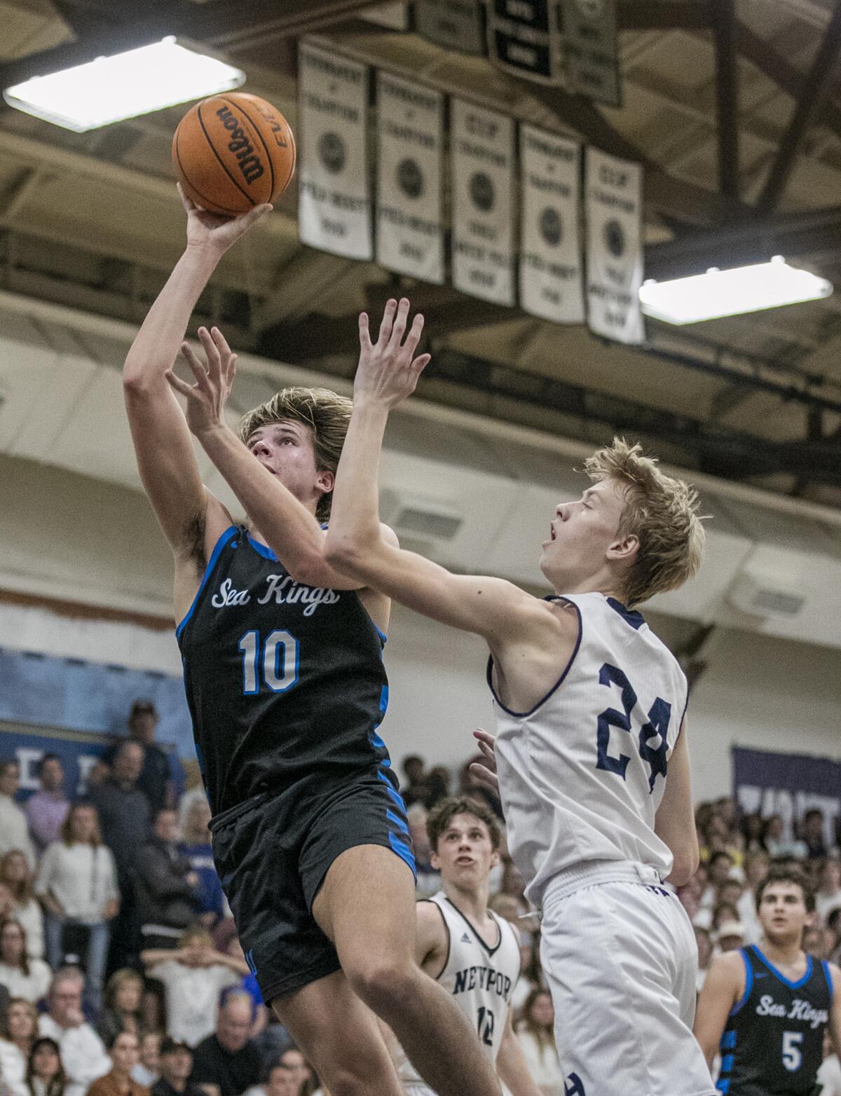 Corona del Mar's Jackson Harlan goes up for a shot against Newport Harbor's Adam Gaa during Wednesday's game.