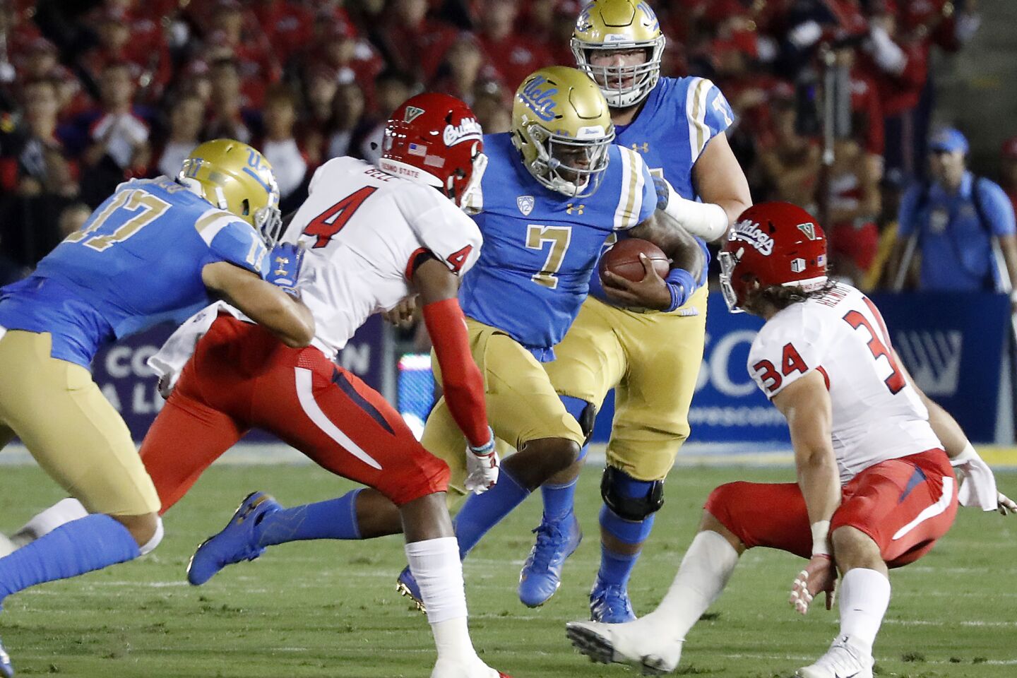 UCLA quarterback Dorian Thompson-Robinson (7) looks for room to run against Fresno State in the first quarter on Saturday at the Rose Bowl.