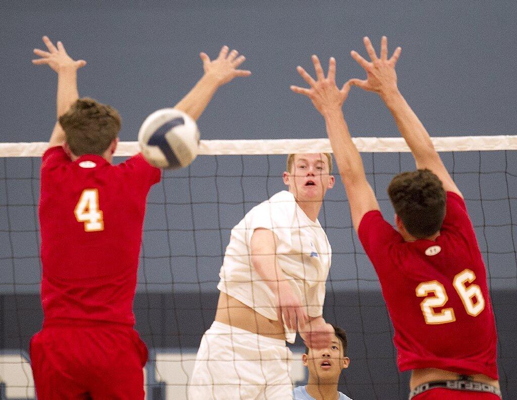 Corona del Mar High's Mitch Haly puts the ball between two Cathedral Catholic middle blockers.