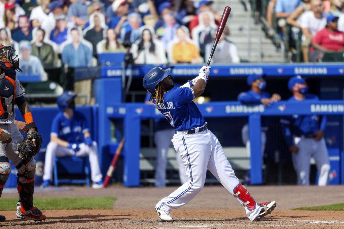 Toronto Blue Jays' Vladimir Guerrero Jr. (27) watches his two-run home run sail over the wall during the fifth inning of a baseball game against the Houston Astros in Buffalo, N.Y., Saturday, June 5, 2021. (AP Photo/Joshua Bessex)
