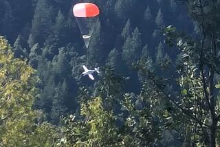 An image provided by the Shelter Cove Fire Dept. shows a plane deploying a parachute system that eased the plane’s landing.