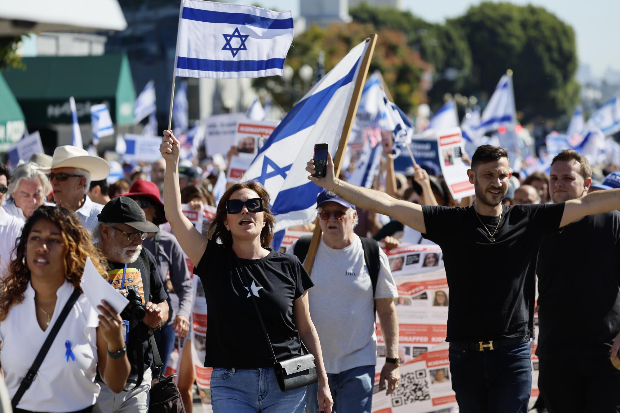 People participate in a solidarity march for Israel en rout to the Museum of Tolerance in Los Angeles.