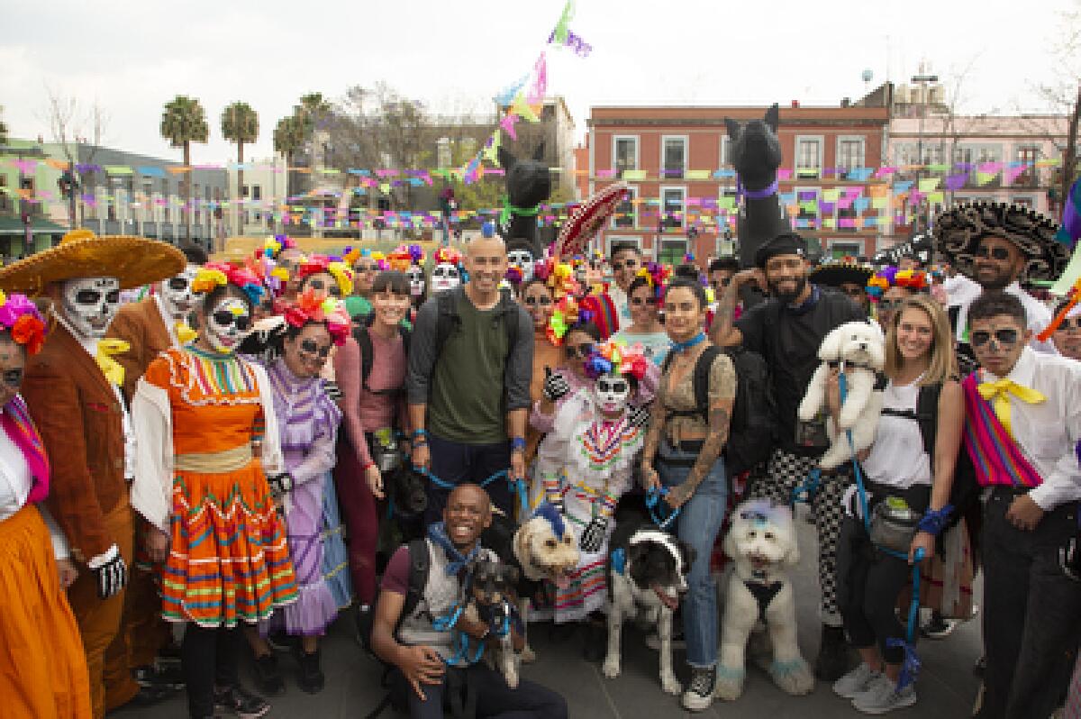 Kioni "Kentucky" Gallahue (center, in green shirt) and his dog, Derby, are contestants in "The Pack" on Amazon Prime Video.