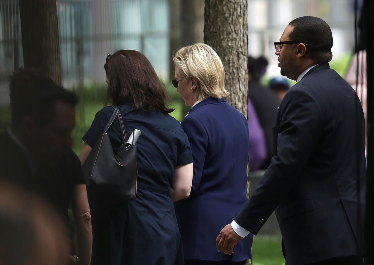 Democratic presidential nominee Hillary Clinton leaves the 9/11 commemoration ceremony Sunday.
