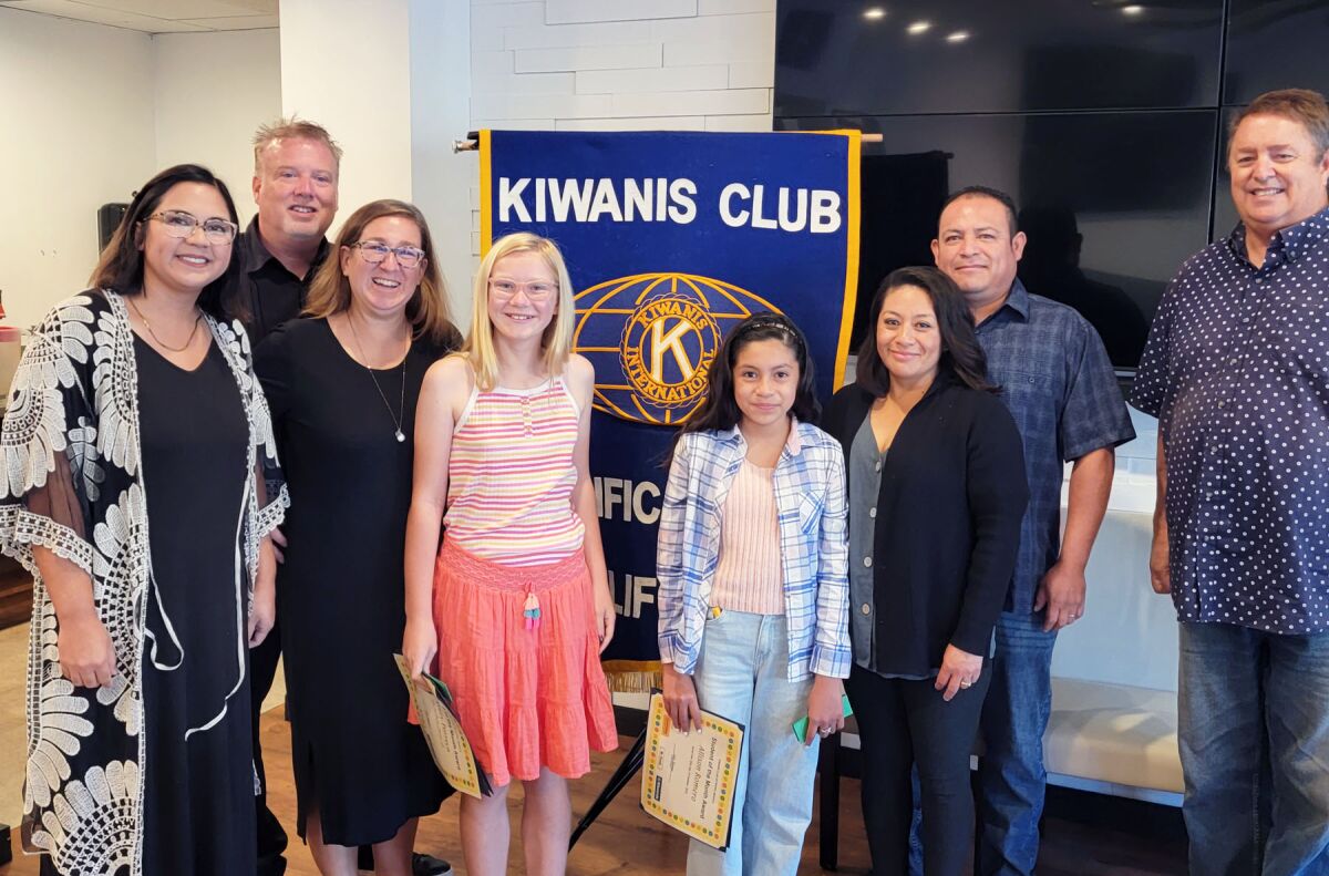 honored students with parents and teachers