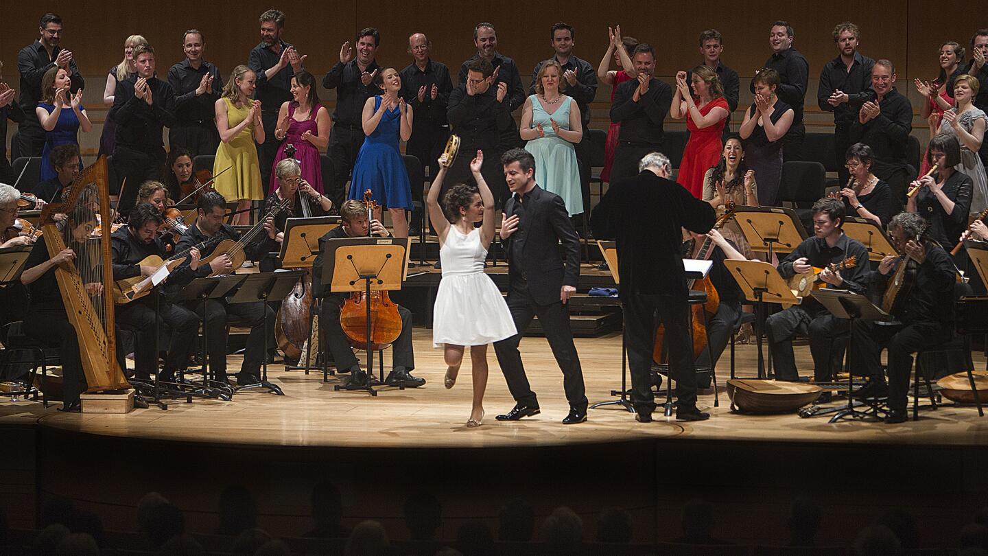 Francesca Aspromonte, left, and Krystian Adam, middle, with John Eliot Gardiner conducting, perform "Vespers of 1610" with English Baroque Soloists and Monteverdi Choir at the Segerstrom Concert Hall.