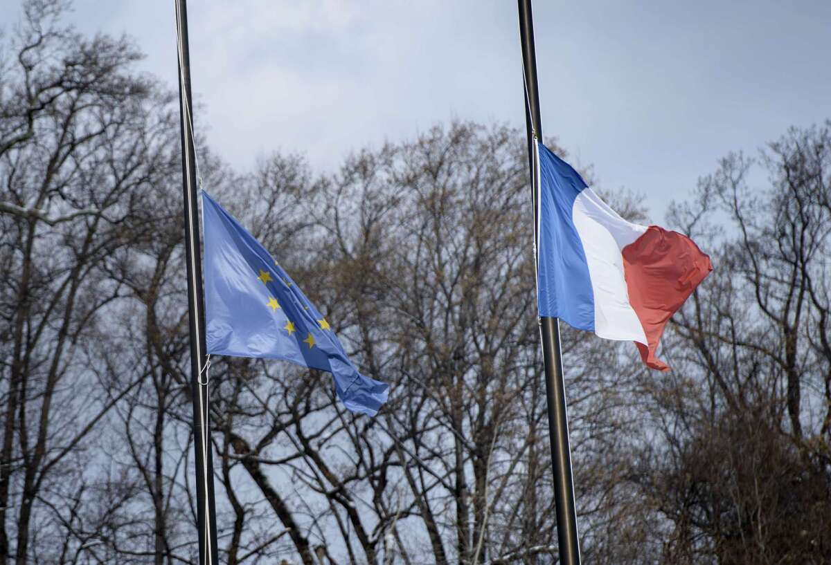 The French and European union flags fly at half staff at the French Embassy January 7, 2015 in Washington, DC. Heavily armed men shouting "Allahu Akbar" stormed the Paris headquarters of a satirical weekly on Wednesday, killing 12 people in cold blood in the worst attack in France in decades. The assault on Charlie Hebdo headquarters in a quiet Paris neighbourhood sparked a massive manhunt as the two gunmen managed to escape, executing a wounded police officer as they fled. AFP PHOTO / BRENDAN SMIALOWSKIBRENDAN SMIALOWSKI/AFP/Getty Images ** OUTS - ELSENT, FPG - OUTS * NM, PH, VA if sourced by CT, LA or MoD **