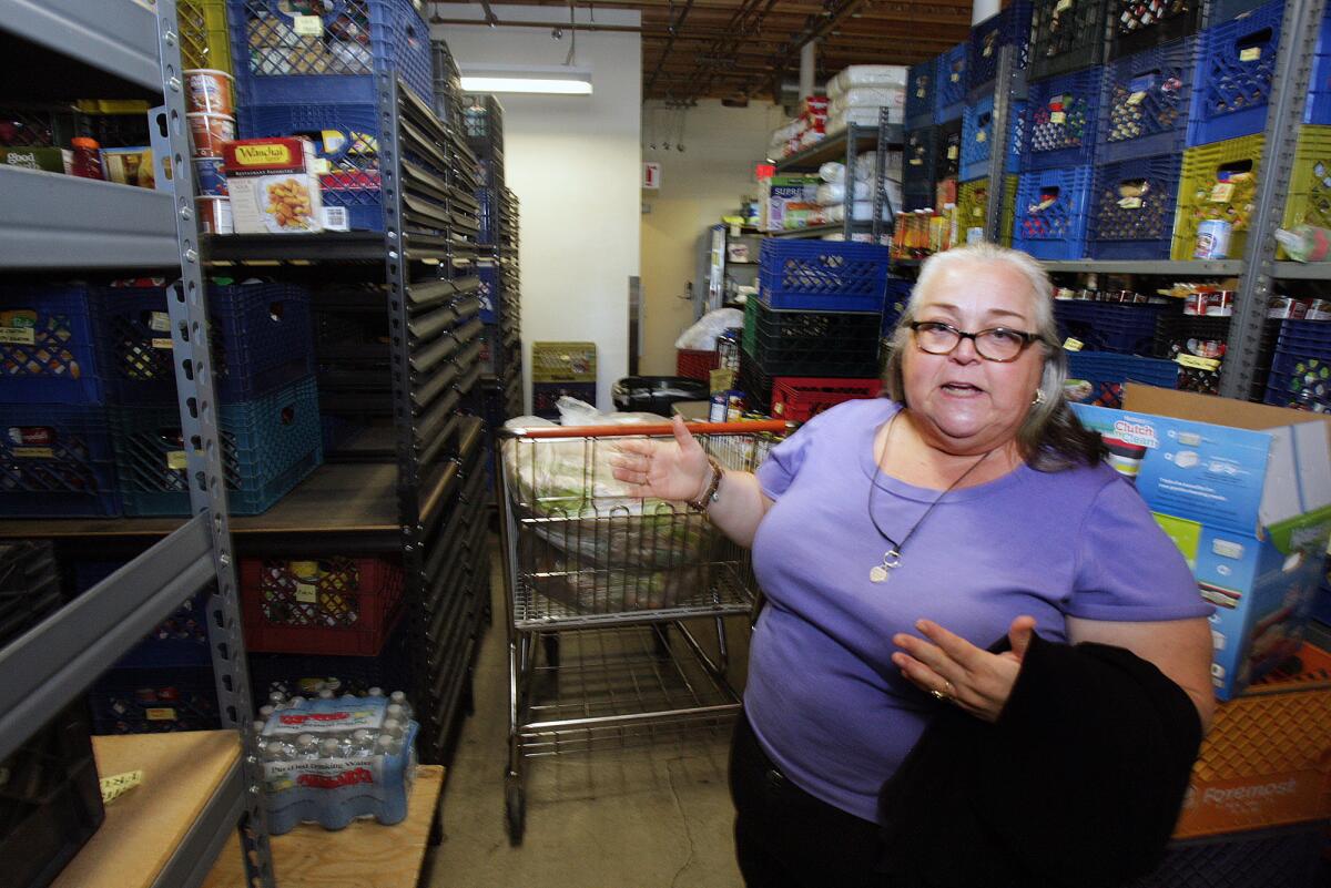 Executive Director Barbara Howell explains the space, that is now filled with shelves filled with food, was a conference area at the Burbank Temporary Aid Center on Tuesday, August 12, 2014. BTAC, in May, purchased the building next to them which will greatly improve the services they offer to existing clients.