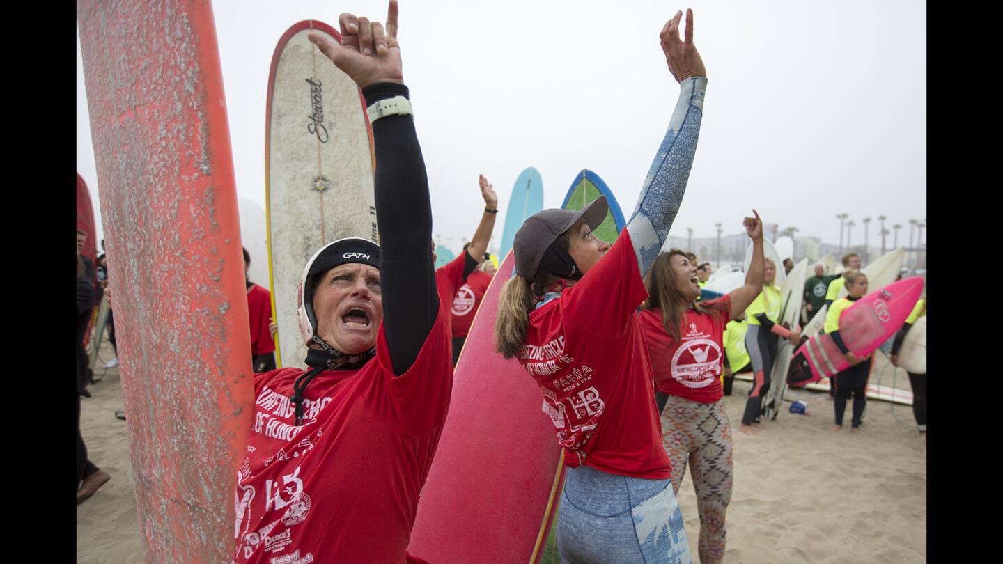 Photo Gallery: 500 surfers paddle out for a record-setting attempt to promote Huntington Beach for the 2024 Olympics