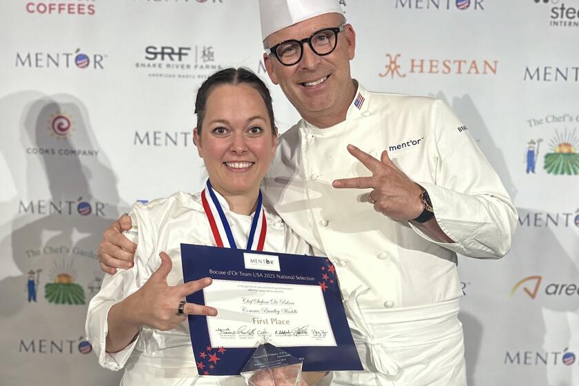 Stefanie De Palma celebrates her win at the Bocuse d'Or candidate competition with William Bradley of Addison. 