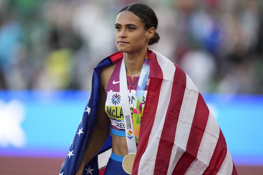 Gold medalist Sydney McLaughlin, of the United States, walks the track after winning the final.
