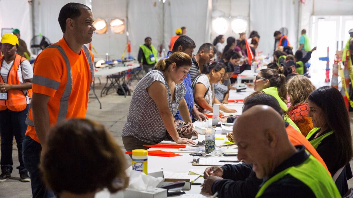 People gather at a disaster relief center in Plant City, Fla., to apply for the Food for Florida program created in the aftermath of Hurricane Irma. More than 4.7 million Floridians received benefits under the program.