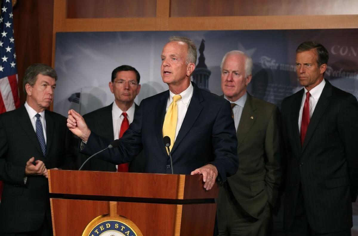 Sen. Jerry Moran (R-Ks.) speaks about President Obama's healthcare reform law while, behind from the left, GOP Sens. Roy Blunt (Mo.), John Barrasso (Wyo.), John Cornyn (Texas) and John Thune (S.D.) listen during a news conference earlier this month. They said they would try to delay and defund key parts of Obamacare through the appropriations process.