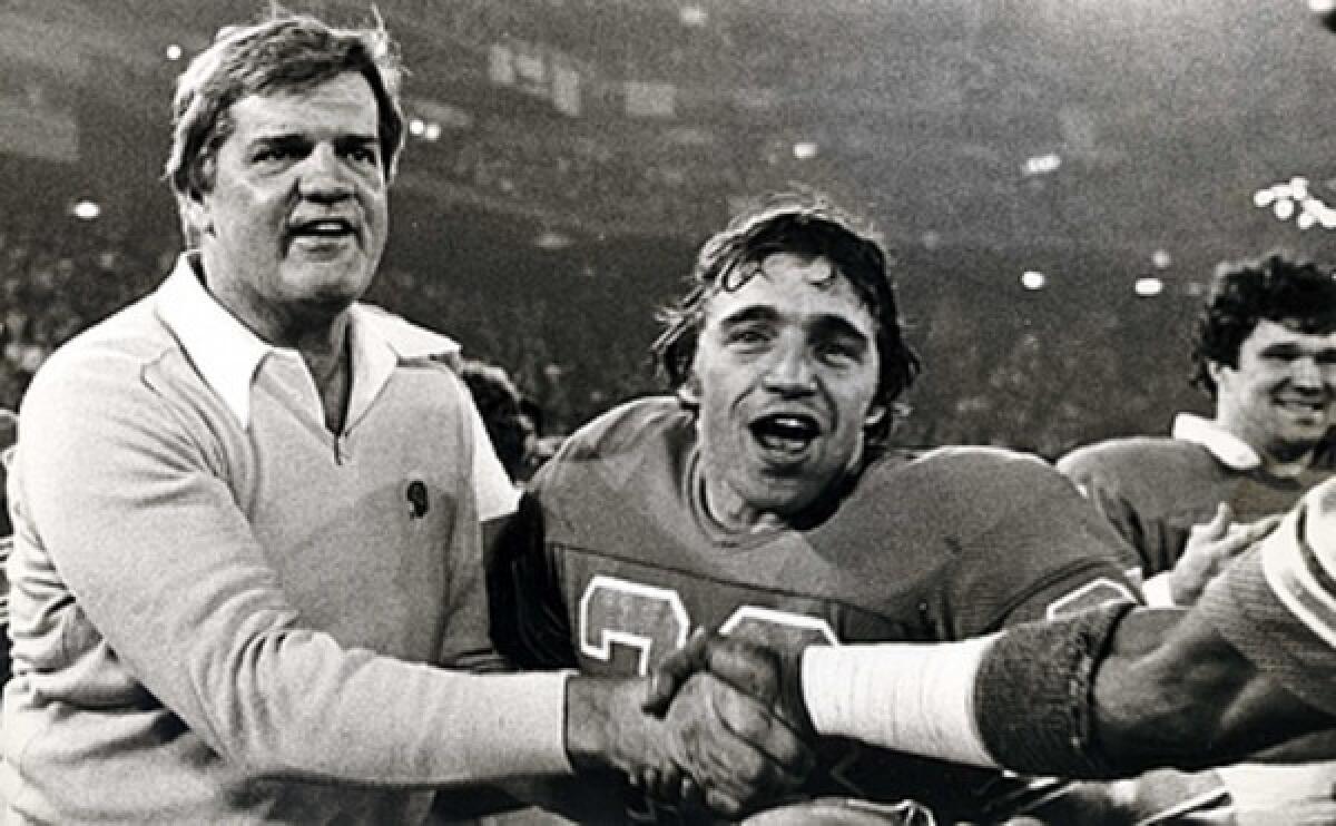 Detroit Lions Coach Monte Clark, left, and defensive back Ray Oldham celebrate after the Lions' 45-7 defeat of the Minnesota Vikings in an NFL football game in 1981. Clark also was a coach for the Miami Dolphins and San Francisco 49ers, and earlier played for the 49ers, Cleveland Browns and Dallas Cowboys.